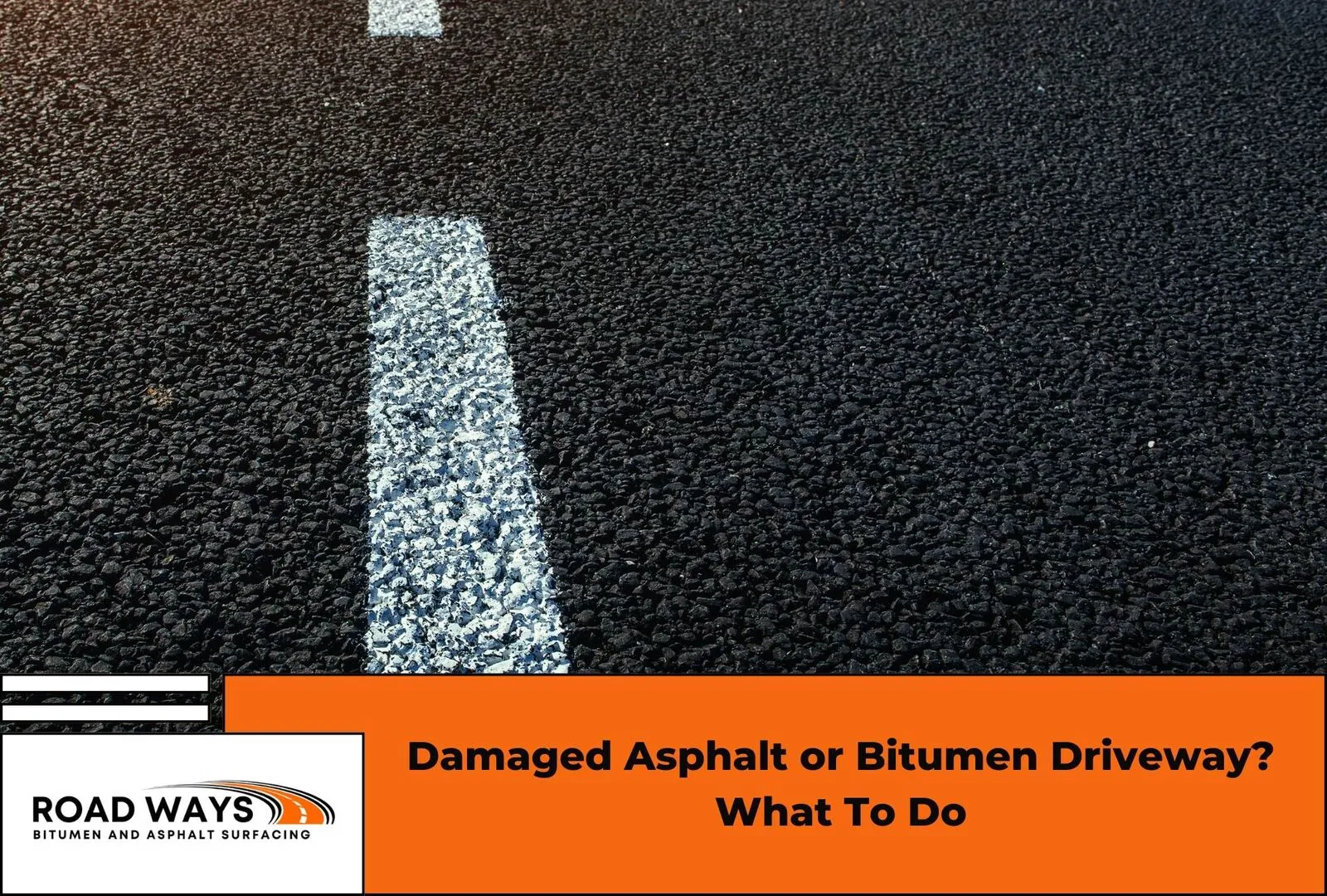 A damaged asphalt driveway surface showing cracking and pothole damage