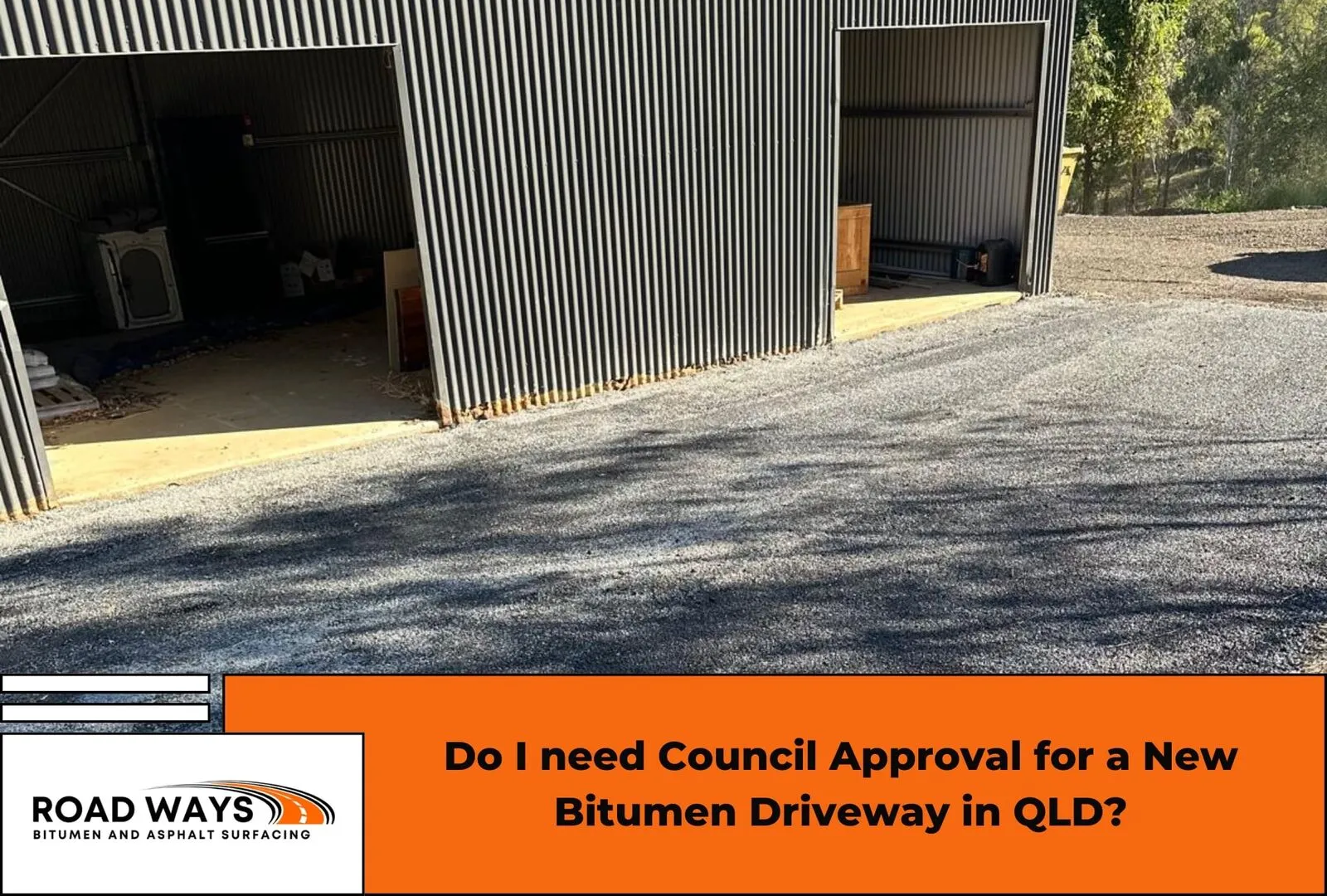 A newly laid bitumen driveway meeting a council crossover